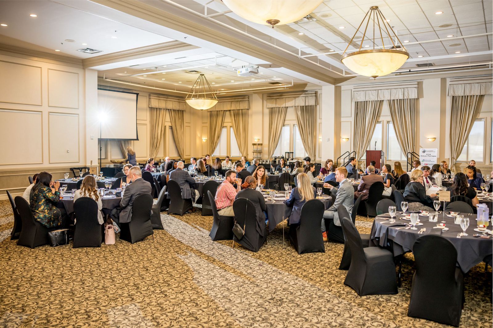 Full conference room with attendees during a presentation