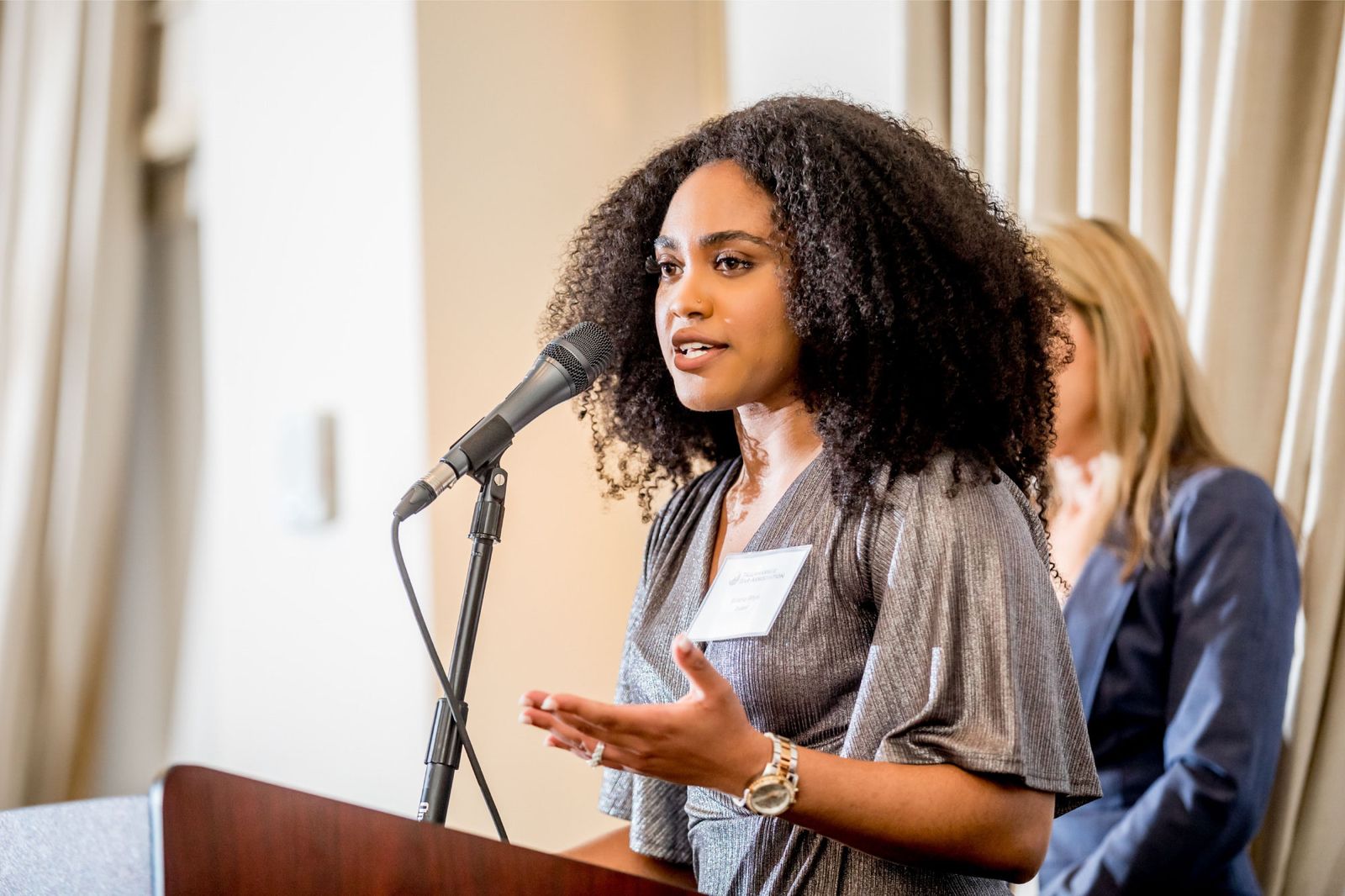 Speaker presenting at a conference podium