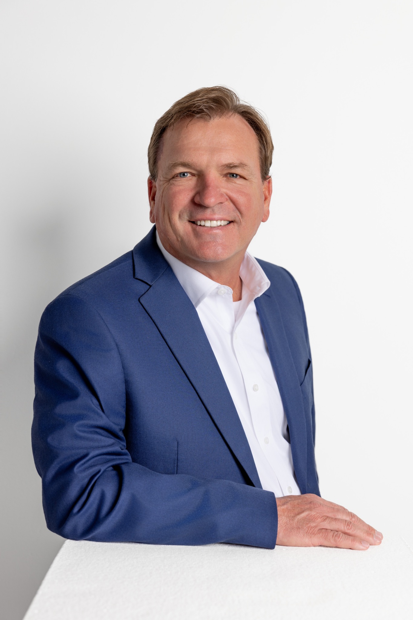 Executive portrait on a light background by Ti Adoro Studios